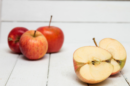 Fresh tasty red apple fruits isolated on a white wooden background.の写真素材