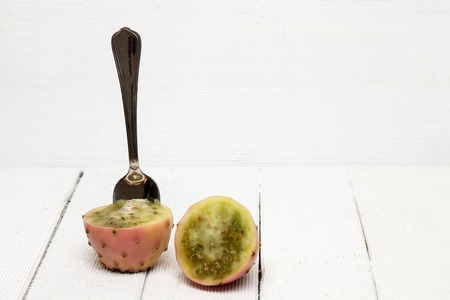 View of a Opuntia ficus-indica cactus fruits on a white wooden background.の写真素材