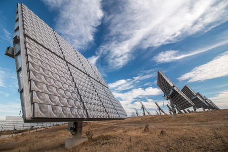 View of a field of photovoltaic solar panels gathering energy on the countryside.
