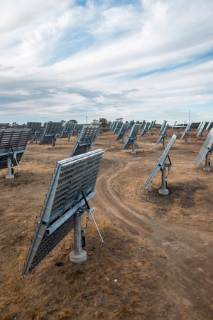 View of a field of photovoltaic solar panels gathering energy on the countryside.の写真素材