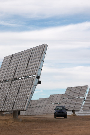 View of a field of photovoltaic solar panels gathering energy on the countryside.
