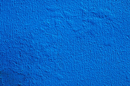Close up view of a painted blue cement wall texture.の写真素材