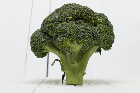 Broccoli vegetable isolated on a white wooden background.の写真素材