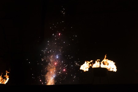 View of fire works sparkles and bowls of fire.