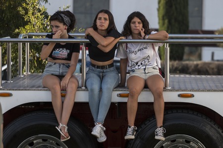 FARO, PORTUGAL - AUGUST 27, 2016: Young girls on the classic vehicles exhibition outdoor event called American Cars Algarve held on Faro city on 27th august 2016.のeditorial素材