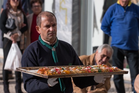 OLHAO, PORTUGAL - DECEMBER 2015: A special day where chef Filipe Martins from Kubidoce creates a giant Bolo Rei (King cake), the portuguese Christmas cake. In the end is offered to people in the street, if you like you can donate money to local associatioのeditorial素材