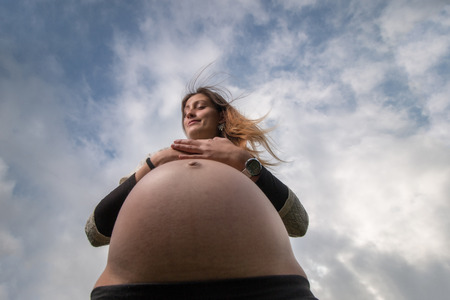 wide angle pregnant girl viewed from below.の写真素材