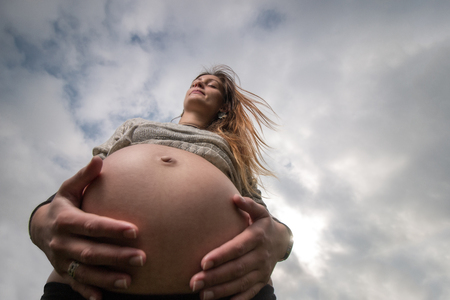 wide angle pregnant girl viewed from below.の写真素材