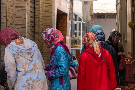 JUNE 9 ,2016 TANGIER -MOROCCO: Several women in typical moroccan clothing, walk in the grocery markets, in the old medina of Tangier, Morocco.のeditorial素材