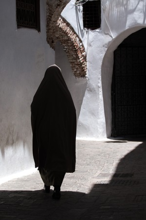 Woman wearing burqa walking in the labirintical medina of Tetouan, Morocco.のeditorial素材