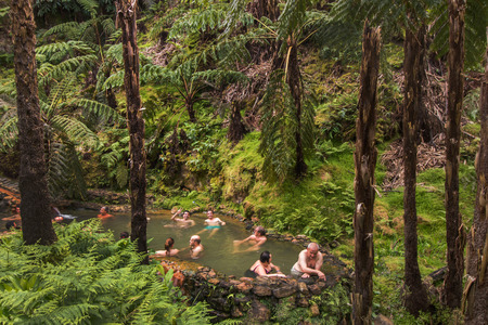 SAO MIGUEL ISLAND, AZORES, PORTUGAL - MAY 24, 2016: Tourists enjoy the natural hot natural thermal pools of Caldeira Velha on Sao Miguel islandのeditorial素材