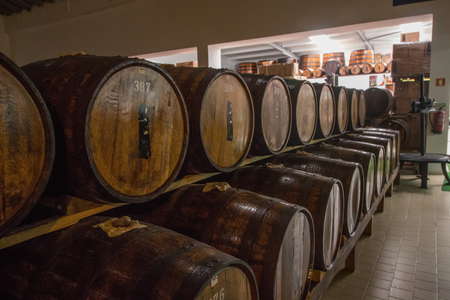 SAO MIGUEL ISLAND, AZORES, PORTUGAL - MAY 24, 2016: Storage of barrels of the Mulher do Capote liquor factory located in Sao Miguel island, Azores, Portugal.のeditorial素材