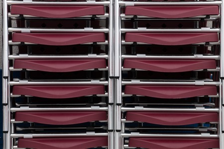 Close up view of a stack of coffee shop chairs.の写真素材