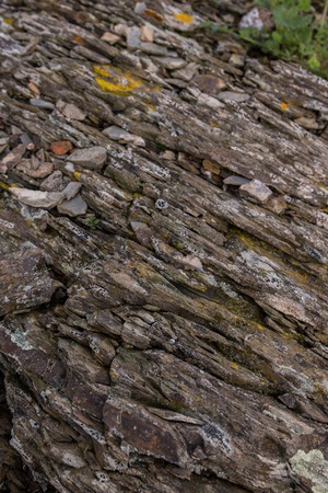 Close up view of an ancient layered rock on the ground.の写真素材