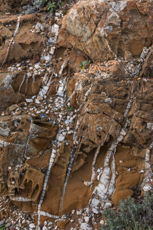 Close up view of an ancient layered rock on the ground.の写真素材