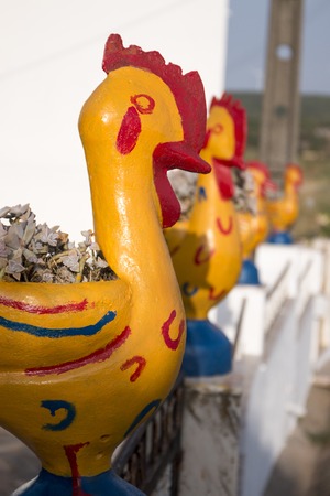 View of crazy yellow chicken flower vases.