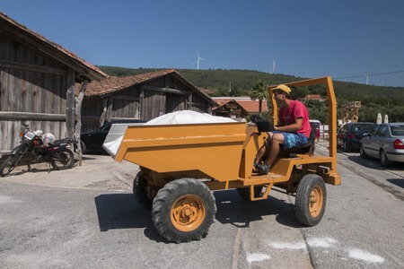 RIO MAIOR, PORTUGAL - July 20th, 2016 : Workers gathering marine salt from the famous saline exploration in Rio Maior.のeditorial素材