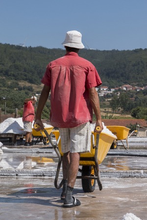 RIO MAIOR, PORTUGAL - July 20th, 2016 : Workers gathering marine salt from the famous saline exploration in Rio Maior.のeditorial素材