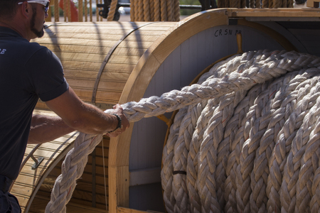 Close up view of a rope wheel on a tall sail ship.