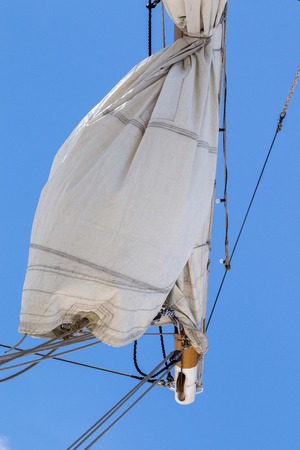 View of majestic Tall Ship with sails with a cloudy sky.の写真素材