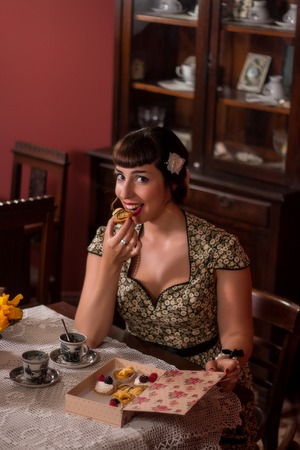 View of a beautiful and cute pinup girl with tea table.の写真素材