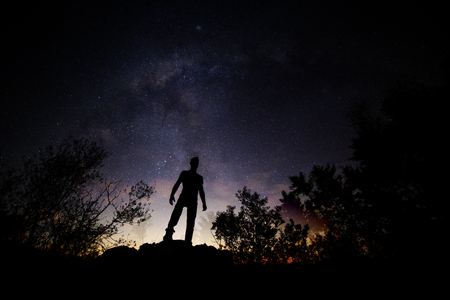 Mysterious view of a silhouette of a man and the stars.の写真素材