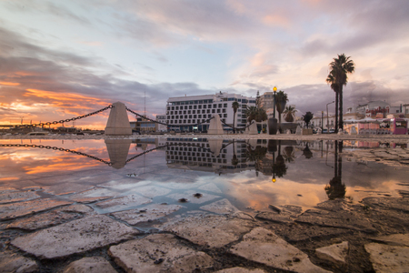 Sunset view of Faro city near the marina creatiing a reflection on the water.のeditorial素材