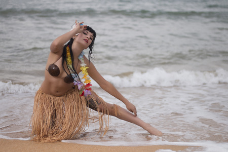 Beautiful and cute hula themed pinup girl fashion on the beach.の写真素材