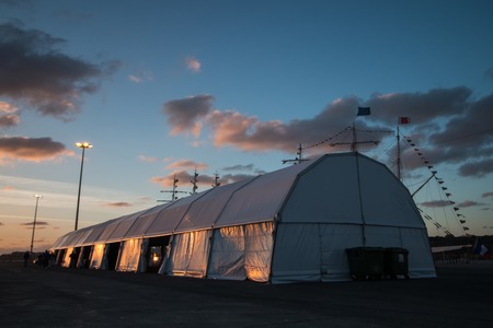 View of a big white tent on sunset.