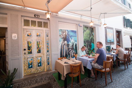 FUNCHAL, PORTUGAL - JUNE 14, 2017: Famous street on Funchal, where a community of artists painted urban art on several doors.のeditorial素材