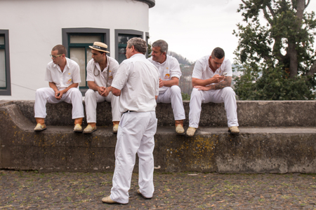 FUNCHAL, MADEIRA - 19th JUNE, 2017: Traditional toboggan riders relaxing until the next trip.のeditorial素材