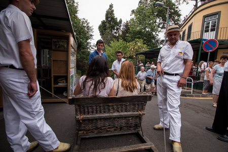 FUNCHAL, MADEIRA - 19th JUNE, 2017: Traditional toboggan riders relaxing until the next trip.のeditorial素材