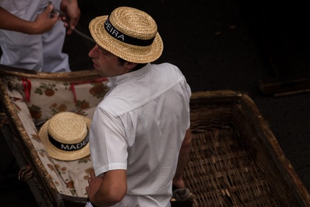 FUNCHAL, MADEIRA - 19th JUNE, 2017: Traditional toboggan riders relaxing until the next trip.のeditorial素材