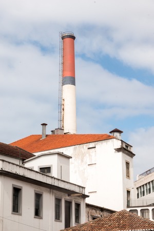 View of a tall factory red chimney in Funchal, Madeira.の写真素材