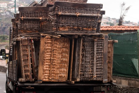 Truck carrying a bunch of toboggan basket cars.の写真素材