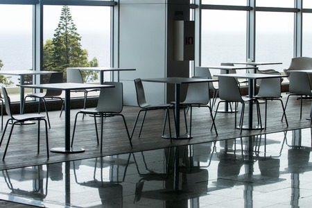 View of several white waiting room chairs and tables.の写真素材