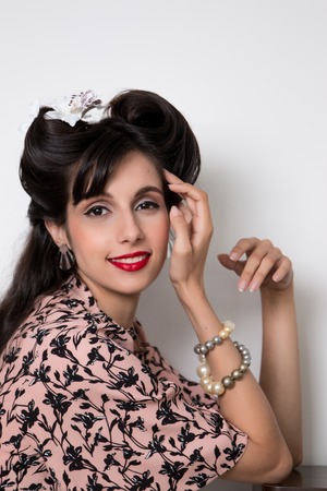 Woman posing with a vintage style retro floral clothing.の写真素材