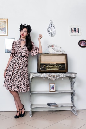 Woman posing with a vintage style retro floral clothing.の写真素材