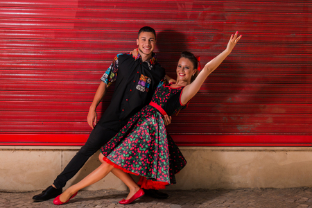 Vintage couple dancing over a red background.の写真素材