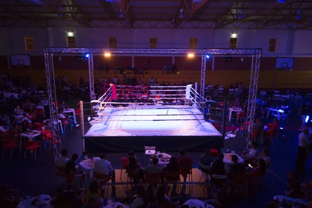 Wide view of a kickboxing event inside a warehouse.のeditorial素材