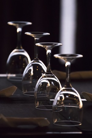 Close up view of several aligned glasses in restaurant.
