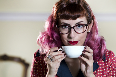 Vintage themed tea girl on a old retro house.の写真素材