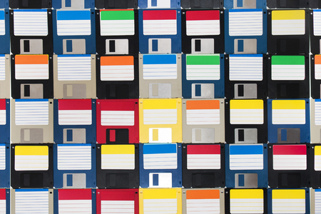 Full view of a background of many colorful floppy disks.の写真素材