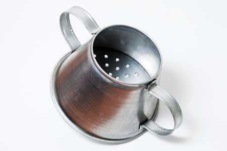 Close view of a metal rustic chestnut roaster isolated on a white background.の写真素材