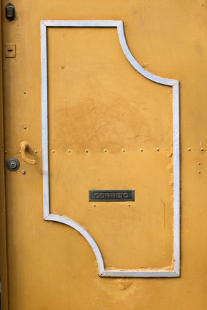 Close up view of a yellow metal door.の写真素材