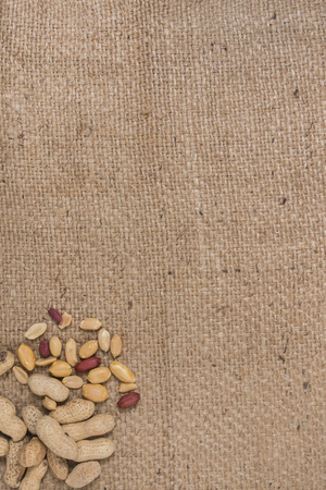 peanuts on a composition on a burlap background.の写真素材