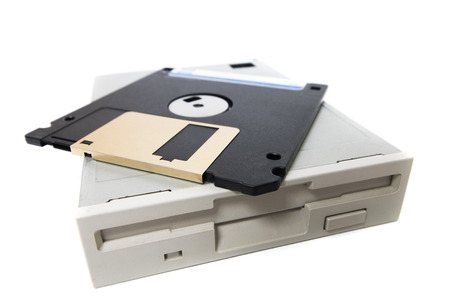 Closeup view of a computer floppy drive, isolated on a white background.