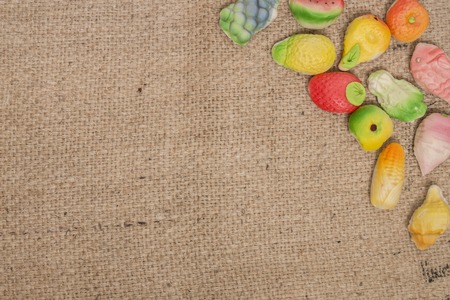 Composition of traditional portuguese fruity sweets over a burlap fabric.の写真素材