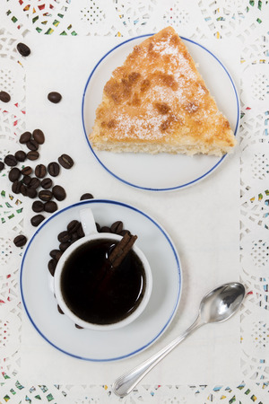 Close view of breakfast with coffee and a piece of coconut cake.の写真素材