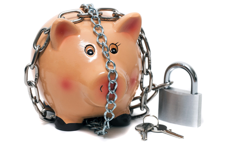Close up view of a cute pink piggy bank with lock isolated on a white background.の写真素材